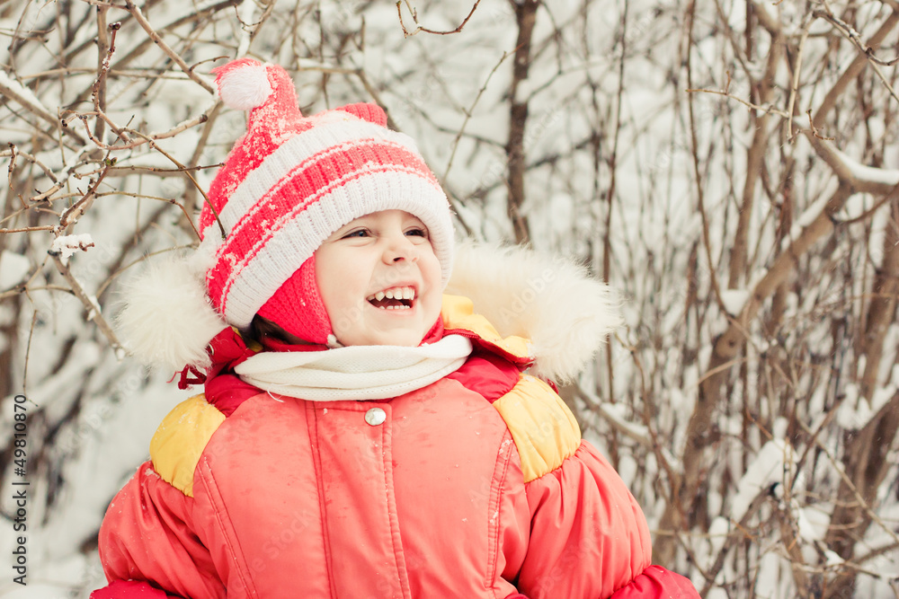 Obraz premium Beautiful happy kid in the red jacket