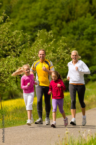 Fototapeta Naklejka Na Ścianę i Meble -  Family running in the meadow for sport
