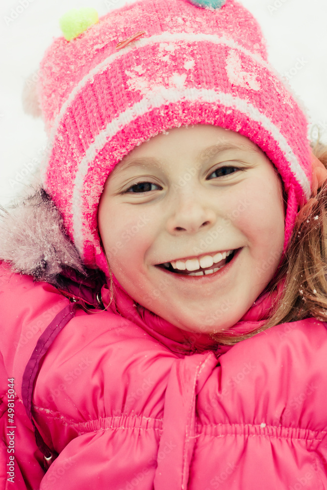 Beautiful happy girl lying on the snow Beautiful happy girl lying on the snow