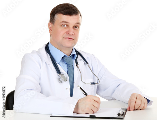 Medical doctor working at desk isolated on white