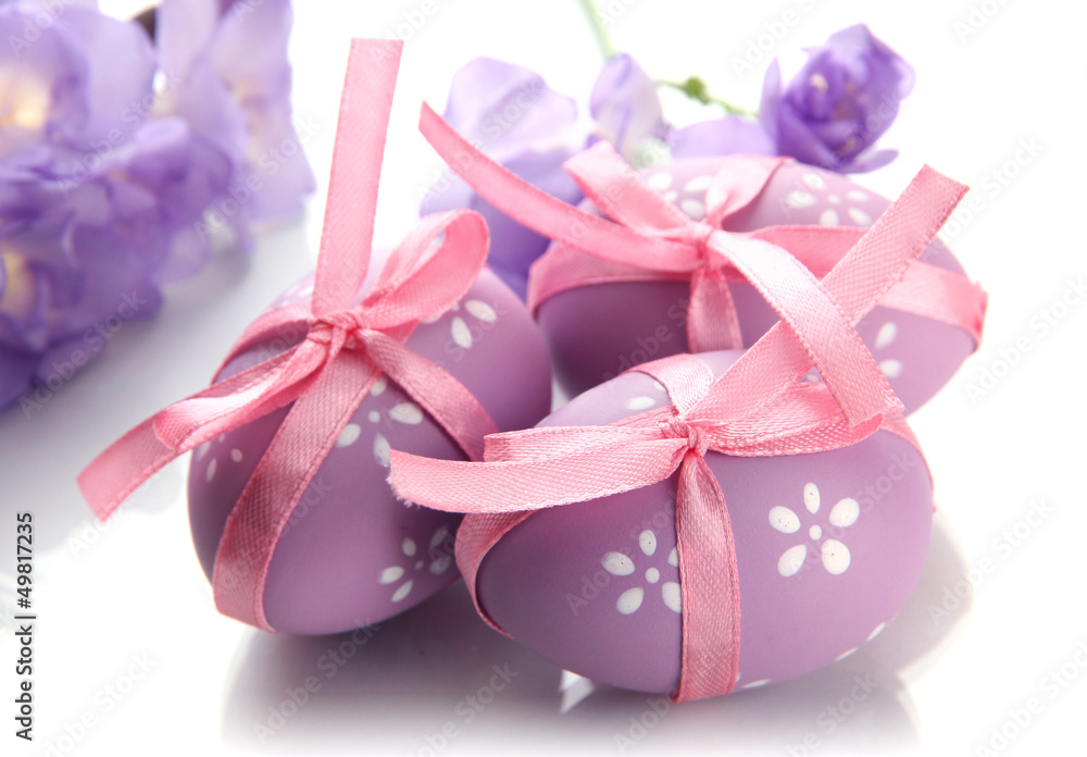 Bright easter eggs with bows and flowers, isolated on white Bright easter eggs with bows and flowers, isolated on white