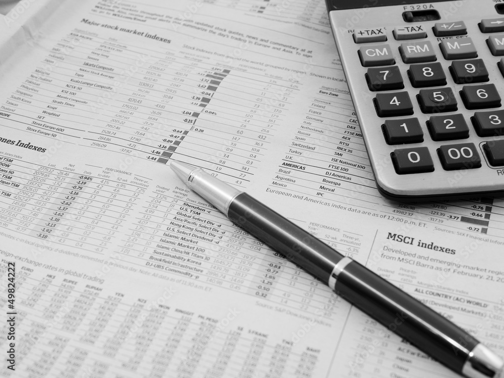 Pen and calculator on business paper Pen and calculator on business paper