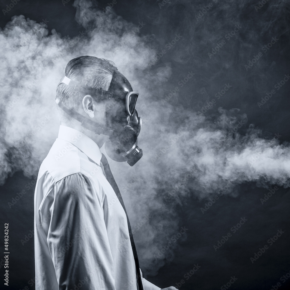 a man in a gas mask goes through the smoke