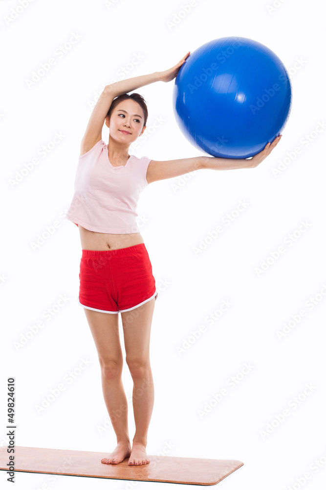 Young woman with gym ball isolated on white Young woman with gym ball isolated on white