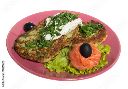 Roasted cutlets of potato with salmon on a plate