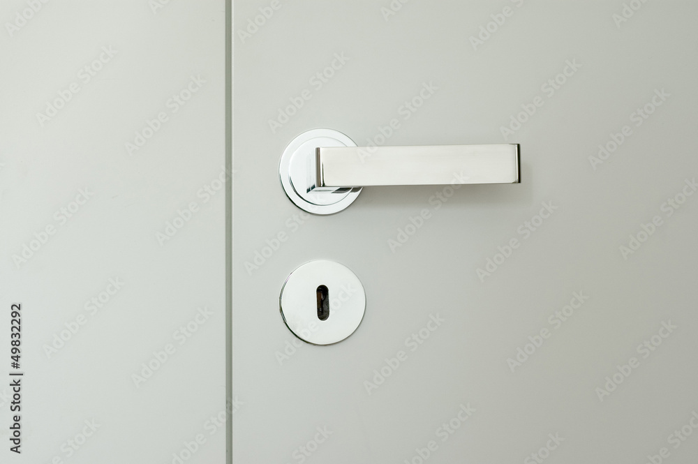 detail of white doors with chrome handle - obrazy, fototapety, plakaty 