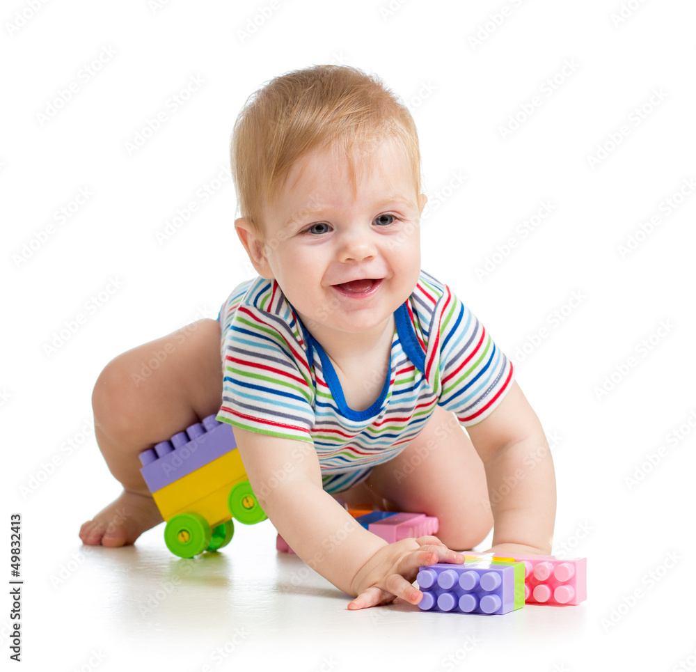 kid boy playing with construction set over white background
