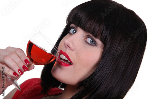 Brunette drinking from wine glass