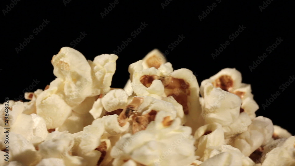 popcorn in rotation on a black background. Macro popcorn in rotation on a black background. Macro