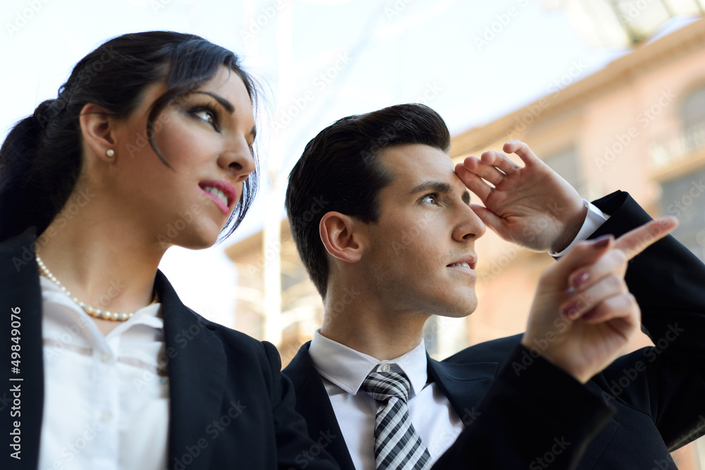 Attractive business people looking at something interesting. Cou Attractive business people looking at something interesting. Cou