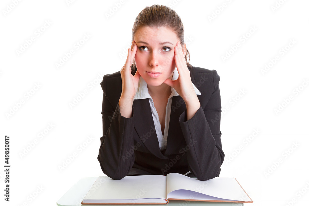 Young brunette hardly studying from the book over white Young brunette hardly studying from the book over white