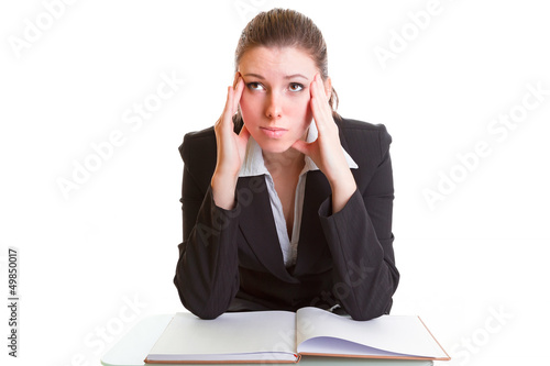 Young brunette hardly studying from the book over white