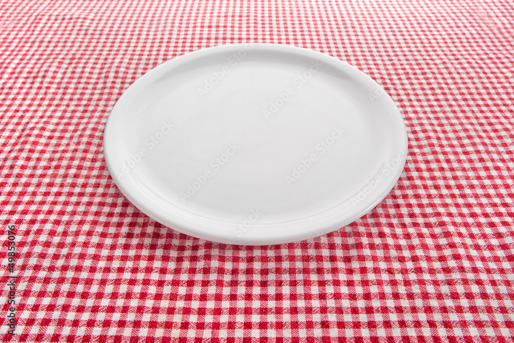 Empty plate on kitchen table Empty plate on kitchen table