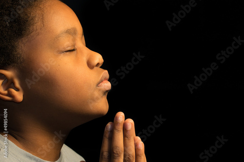 Praying African American boy