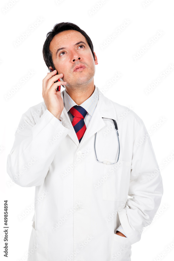 Pensive doctor talking on cell phone, isolated on white Pensive doctor talking on cell phone, isolated on white