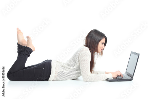 Beautiful woman lying and typing in a laptop