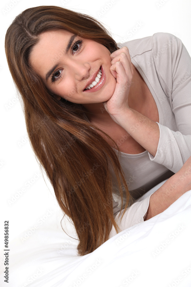 Fototapeta premium Young woman laid on a bed