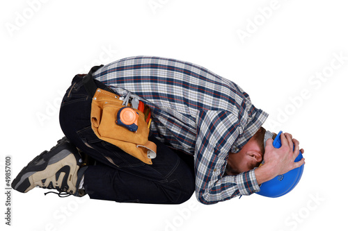 Fotografia Construction worker curled up