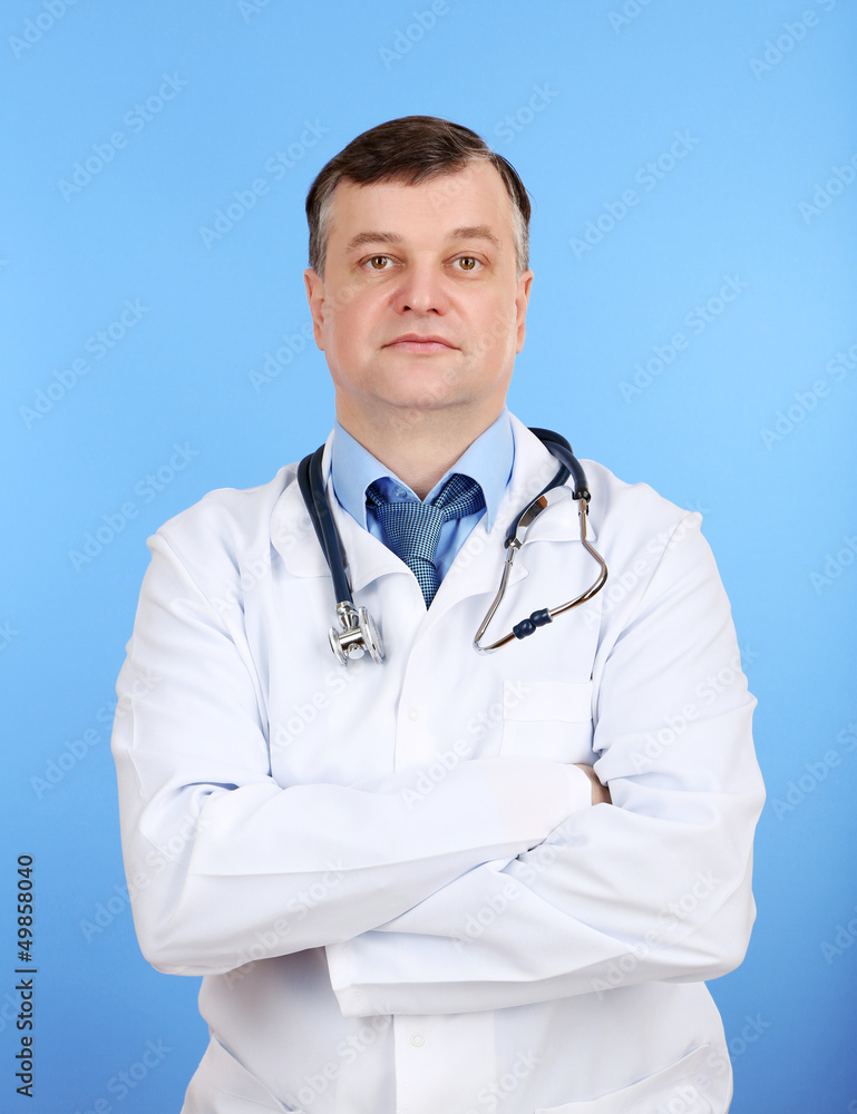 Medical doctor with stethoscope on blue background Medical doctor with stethoscope on blue background