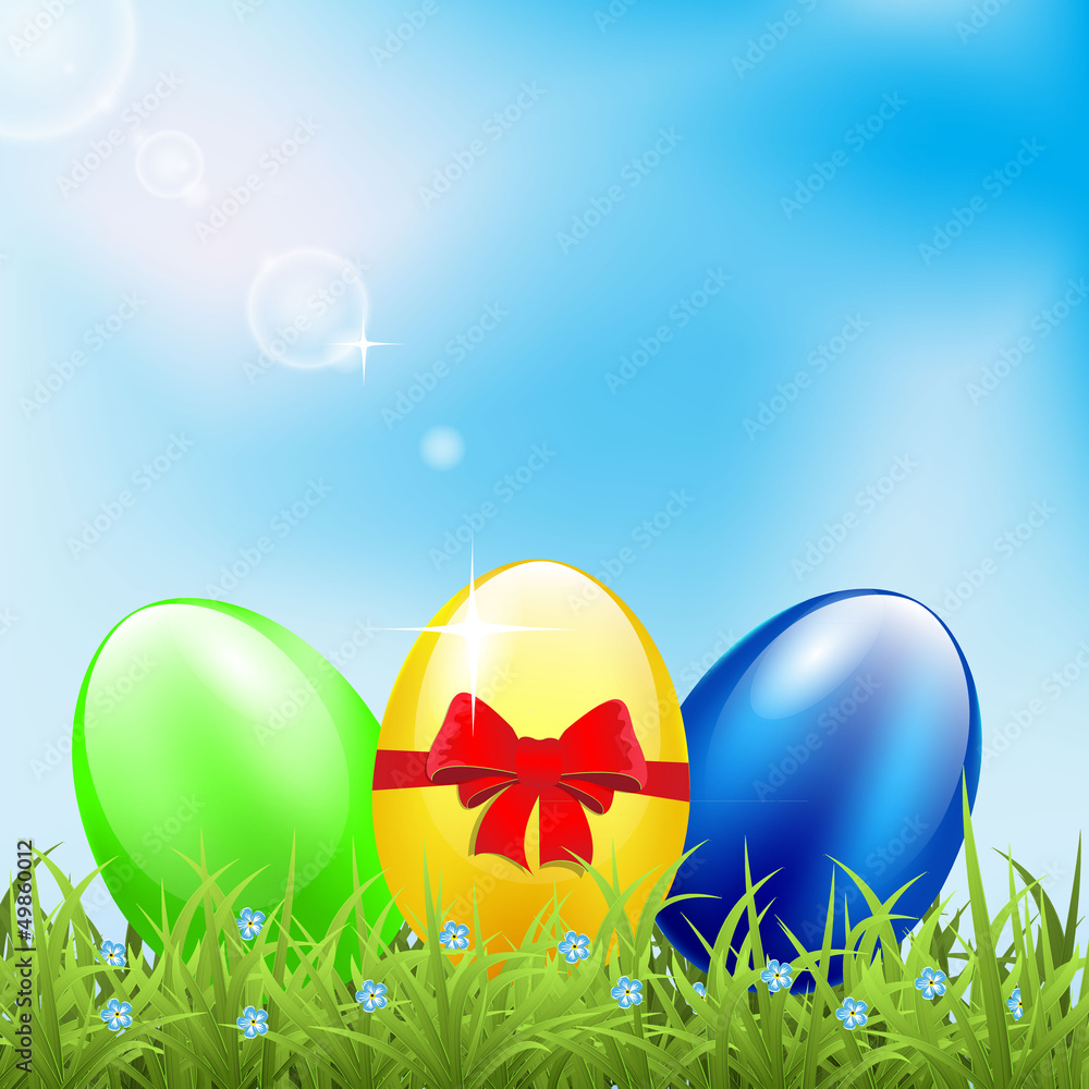 Greeting card with easter eggs on meadow