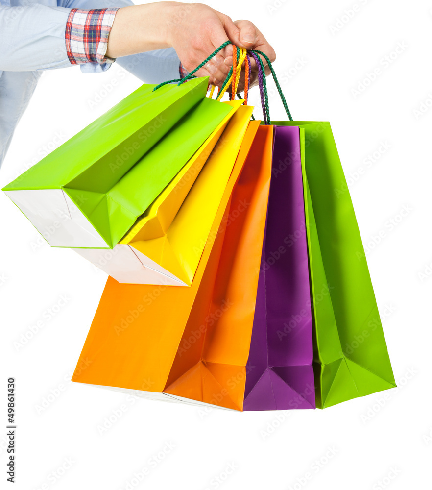Hand holding multicolored paper bags