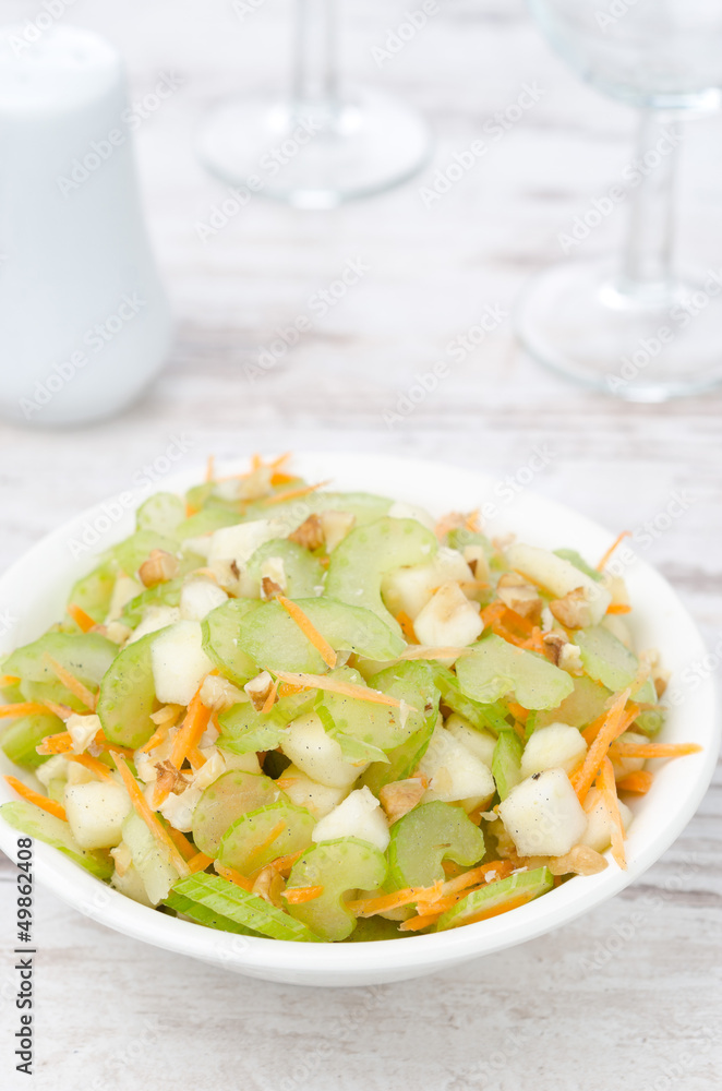 salad with celery, carrots and apples vertical