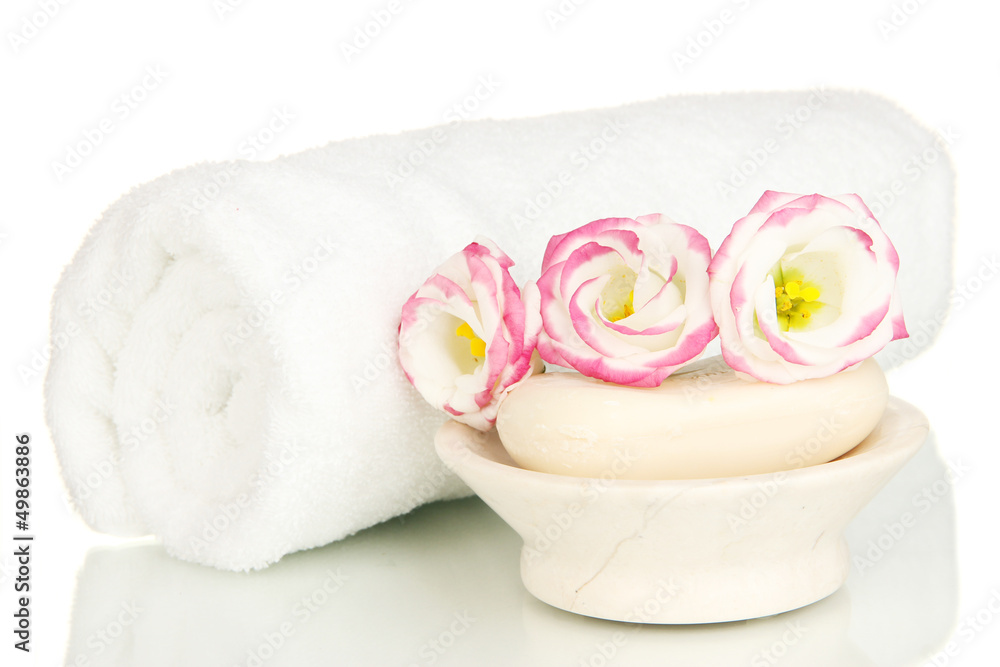 Rolled white towel, soap bar and beautiful flower isolated Rolled white towel, soap bar and beautiful flower isolated