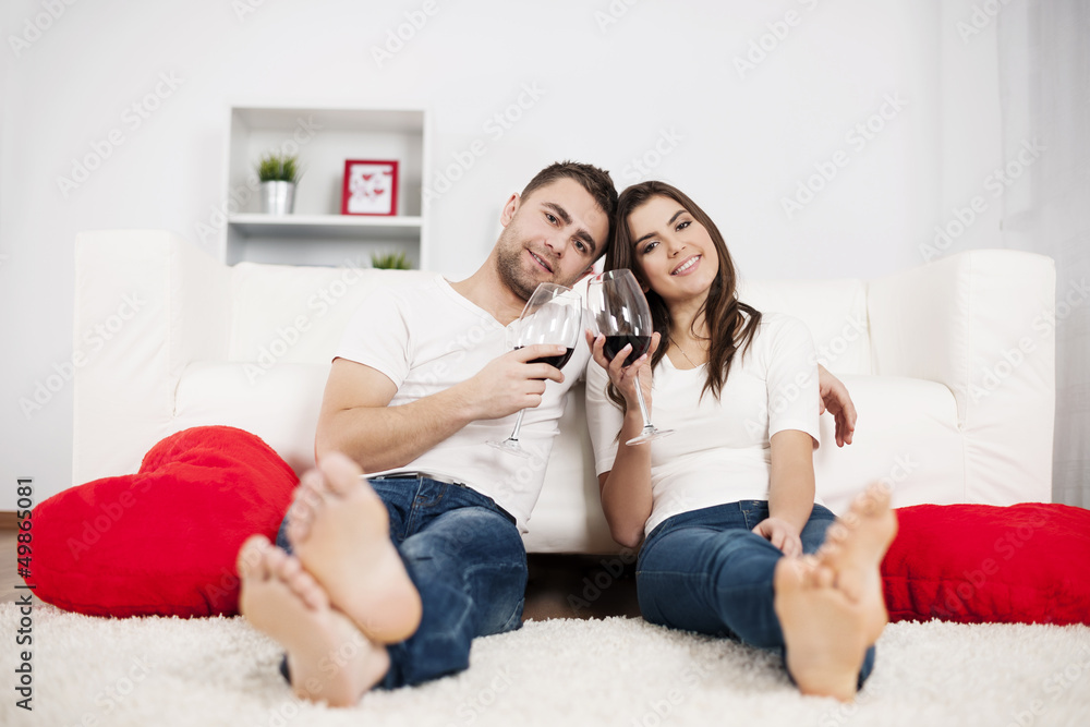 Romantic couple drinking wine at home Romantic couple drinking wine at home