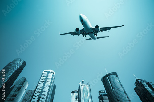 airplane with modern buildings skyline