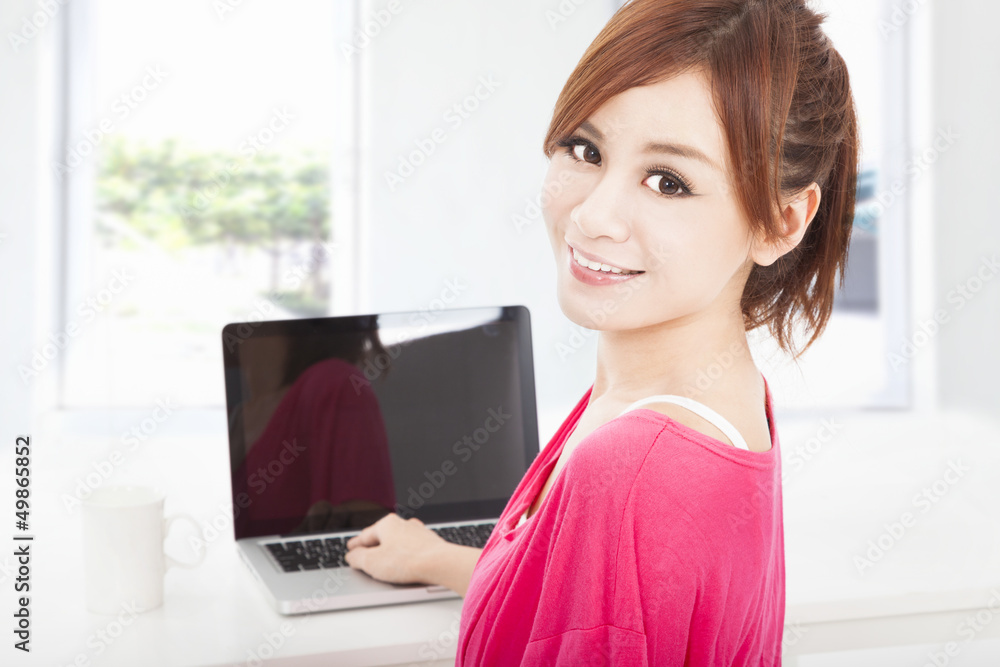 smiling young woman sitting with laptop computer smiling young woman sitting with laptop computer