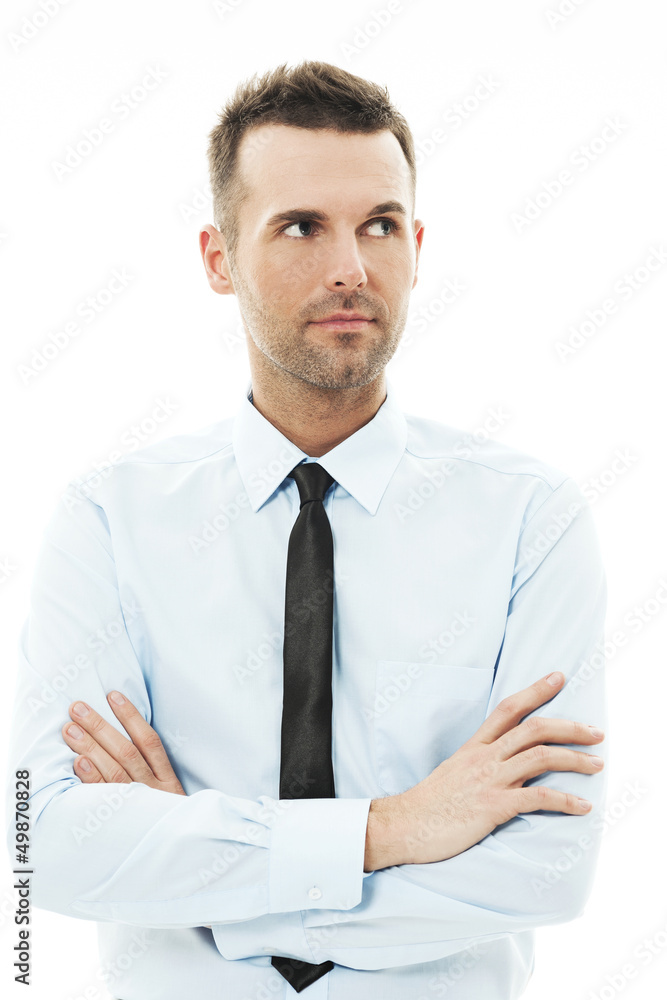 Handsome businessman with arms crossed looking away Handsome businessman with arms crossed looking away