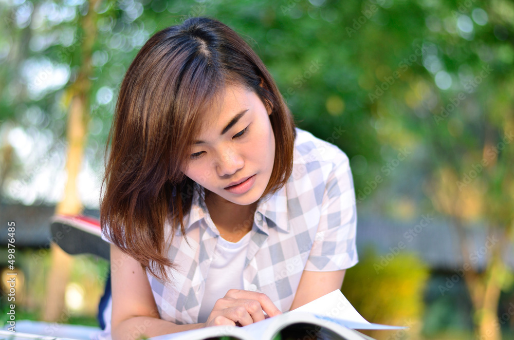 Beautiful young asian student is reading Beautiful young asian student is reading