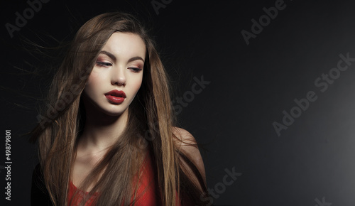 Portrait of a beautiful young woman in a red dress.