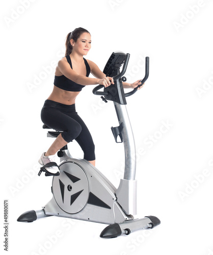 Young brunette woman on bike  exerciser