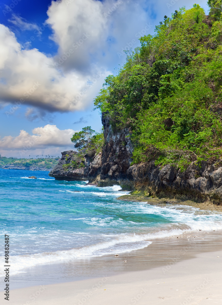 View from a sandy beach on rocks at ocean. Indonesia, Bali View from a sandy beach on rocks at ocean. Indonesia, Bali