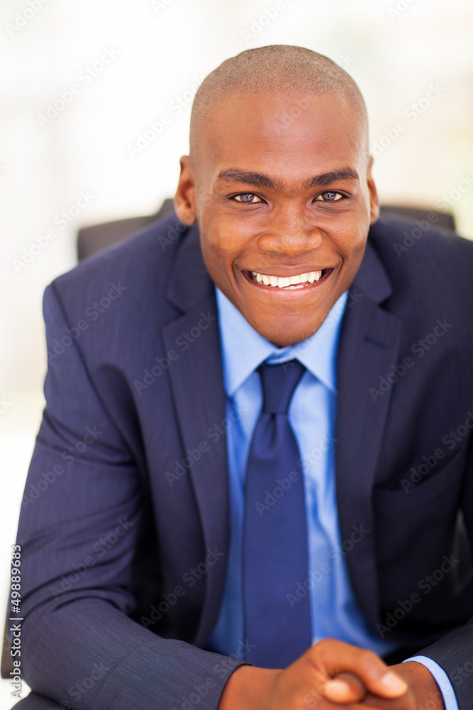 handsome black businessman sitting on office chair handsome black businessman sitting on office chair