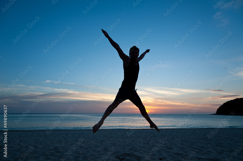 Fototapeta premium Happy man jumping on the beach