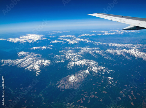 View of a Snowcapped Mountain Landscape from an Airplane