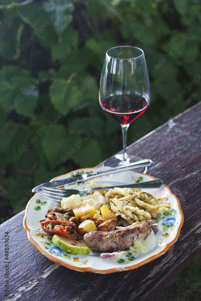 Meal served on a plate with a wineglass, Italy Meal served on a plate with a wineglass, Italy