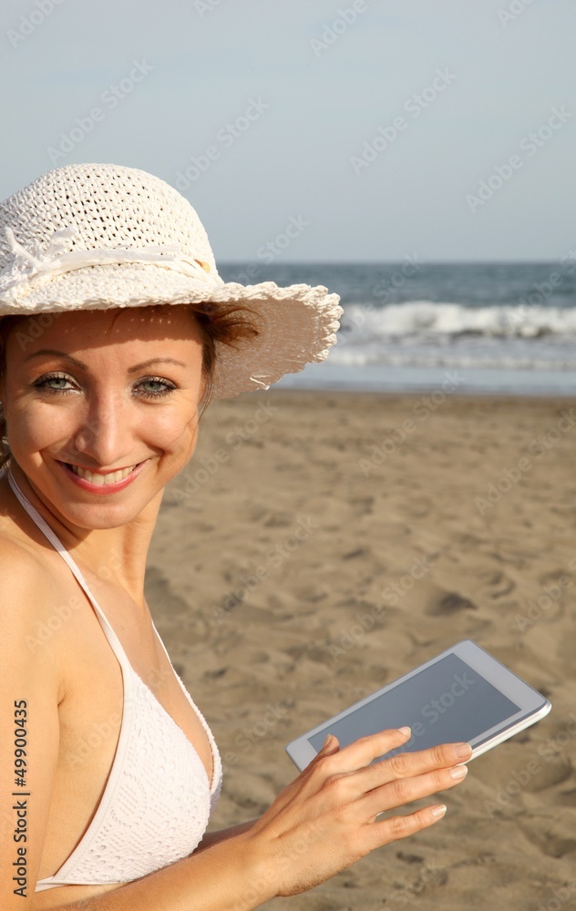 woman at the beach with tablet-pc