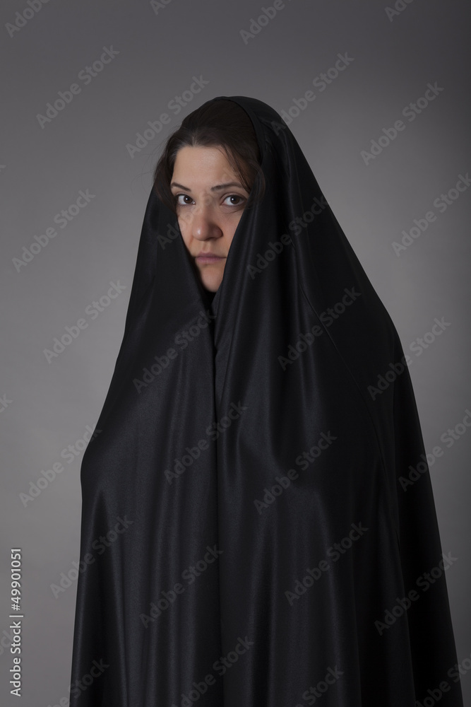 Woman covered with black veil