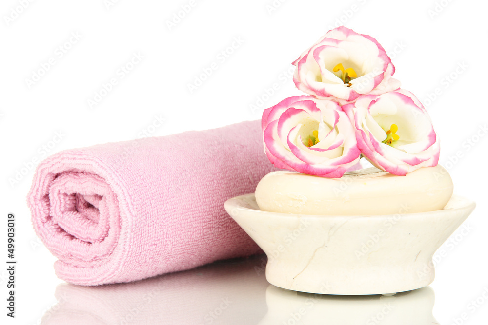 Rolled pink towel, soap bar and beautiful flower isolated Rolled pink towel, soap bar and beautiful flower isolated