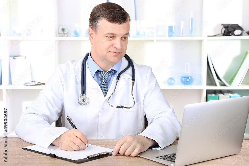 Medical doctor working at desk Medical doctor working at desk