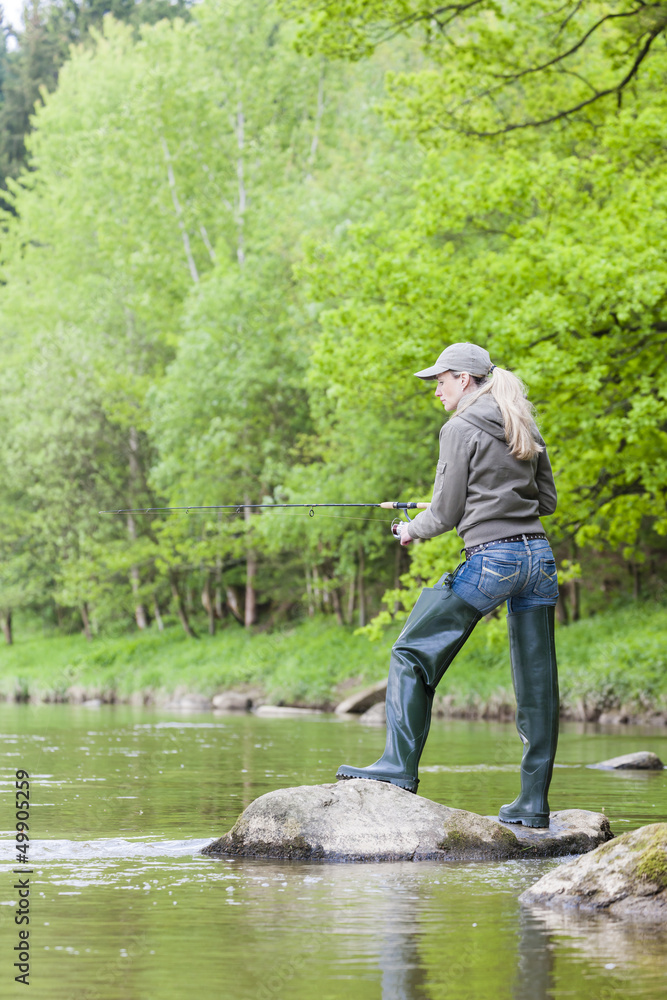 woman fishing in Sazava river, Czech Republic woman fishing in Sazava river, Czech Republic