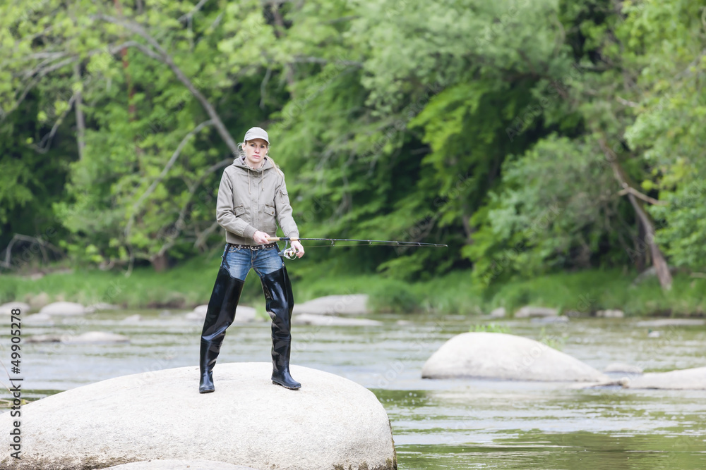 woman fishing in Sazava river, Czech Republic woman fishing in Sazava river, Czech Republic
