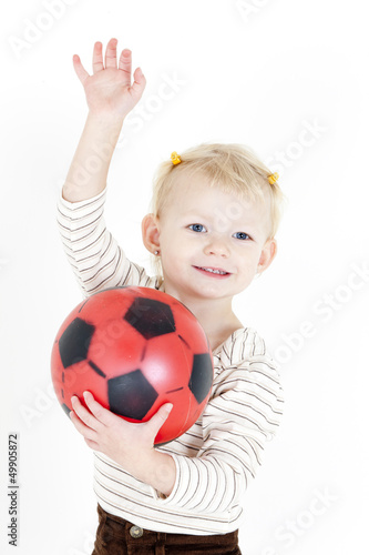 portrait of little girl playing with a ball
