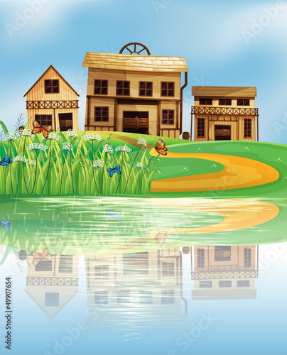 A pond with a reflection of the wooden houses