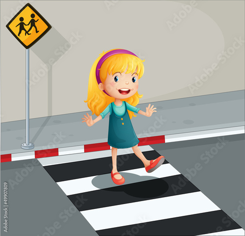 A young lady crossing the pedestrian lane