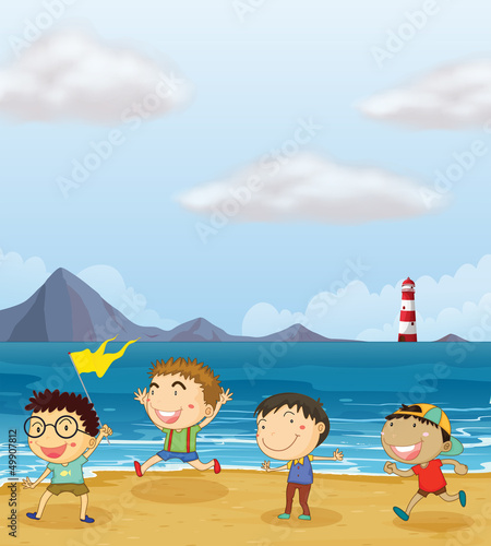 Four boys playing at the beach