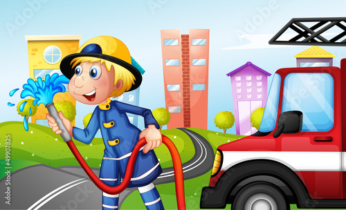 A fireman with a hose at the street